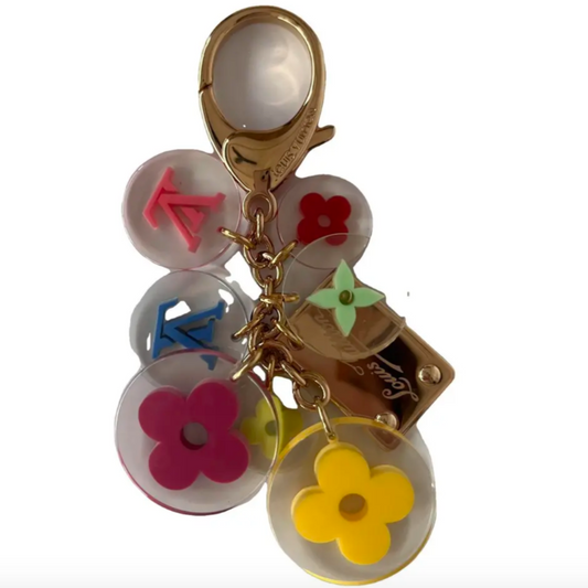 Colorful keychain with floral and geometric designs on a white background